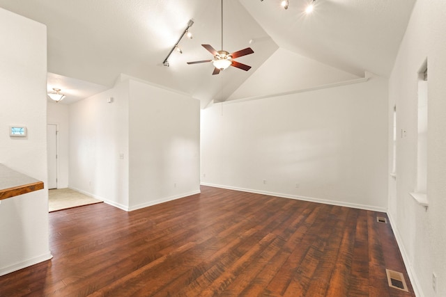 interior space featuring a ceiling fan, visible vents, wood finished floors, and vaulted ceiling