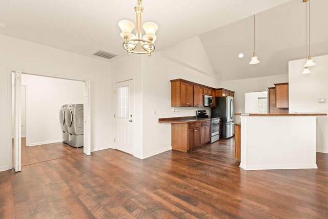 154 Palmer Dr, Kalispell, MT 59901 - kitchen with brown cabinetry, an inviting chandelier, visible vents, separate washer and dryer, and stainless steel appliances