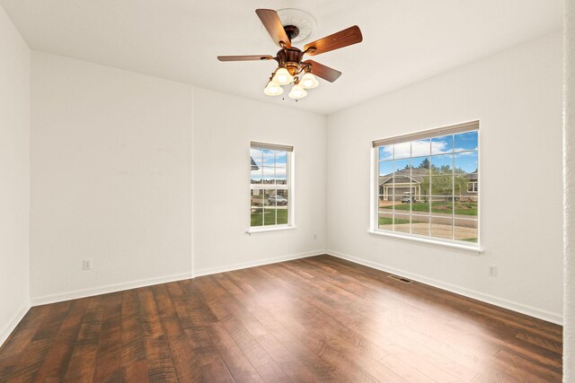 154 Palmer Dr, Kalispell, MT 59901 - unfurnished room featuring baseboards, a wealth of natural light, wood finished floors, and visible vents