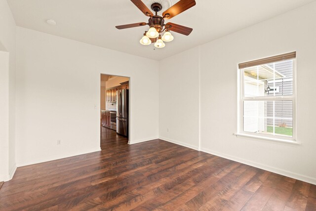 154 Palmer Dr, Kalispell, MT 59901 - unfurnished room featuring a healthy amount of sunlight, baseboards, a ceiling fan, and dark wood-type flooring