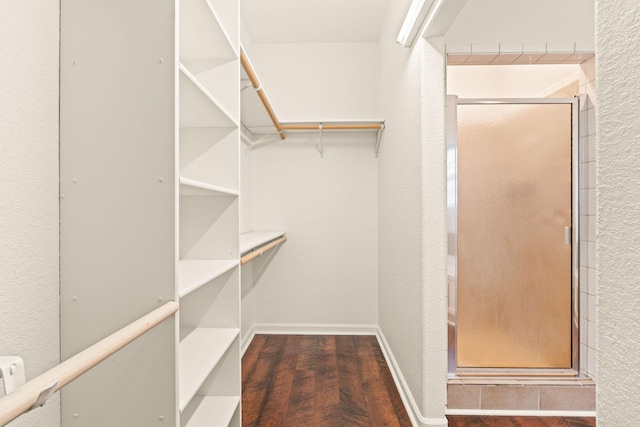 walk in closet with wood finished floors