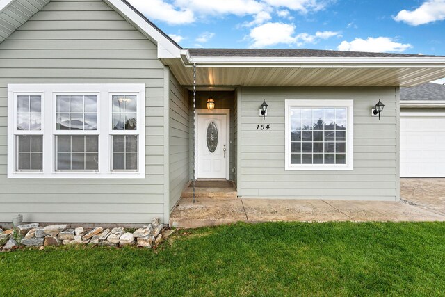 154 Palmer Dr, Kalispell, MT 59901 - doorway to property with a lawn and an attached garage