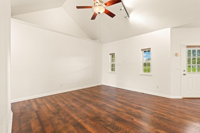 unfurnished room with track lighting, a ceiling fan, baseboards, vaulted ceiling, and dark wood-style floors