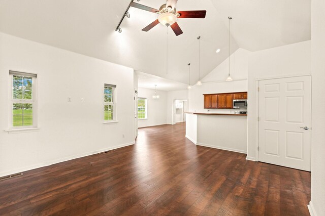 154 Palmer Dr, Kalispell, MT 59901 - unfurnished living room with ceiling fan, track lighting, high vaulted ceiling, dark wood finished floors, and visible vents
