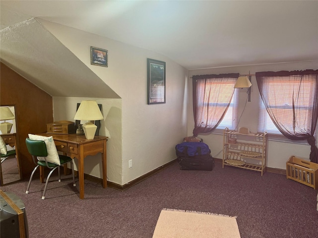 carpeted home office featuring baseboards and vaulted ceiling