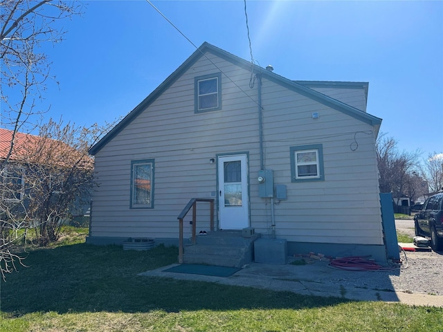 back of property featuring a yard