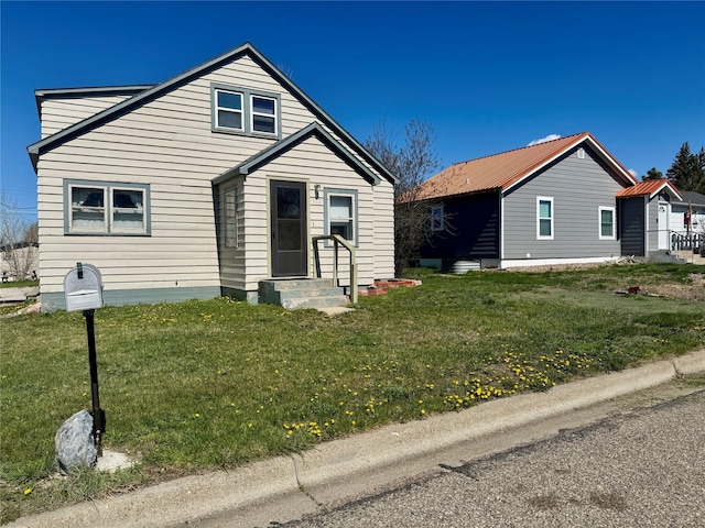 bungalow-style home featuring a front yard