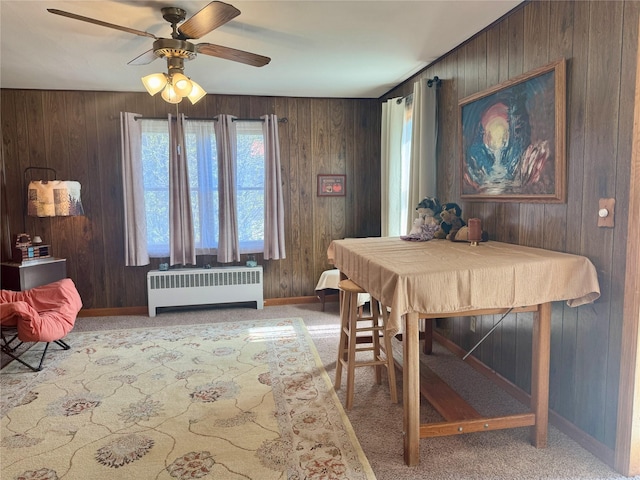 dining space featuring ceiling fan, light colored carpet, baseboards, and radiator