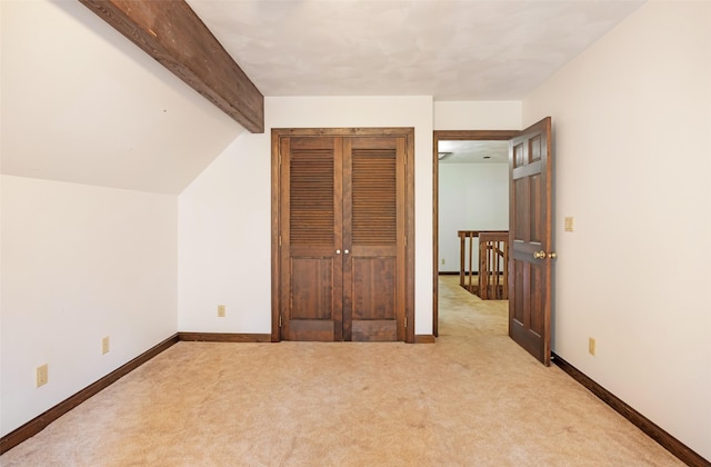 bonus room with carpet floors, baseboards, and vaulted ceiling with beams
