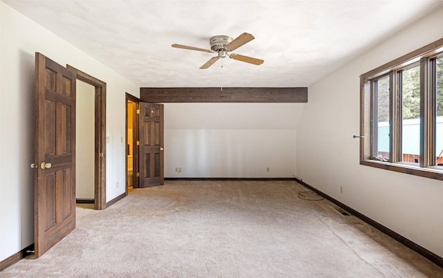 spare room with baseboards, light carpet, a ceiling fan, and visible vents