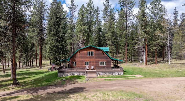 view of front of home with a deck and a front yard