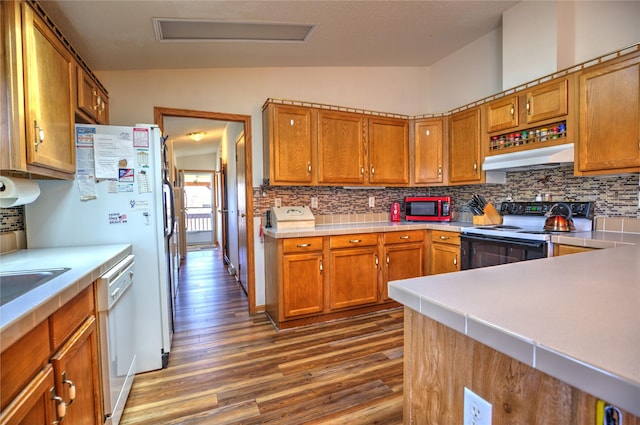 kitchen with decorative backsplash, range with electric stovetop, dark wood-style flooring, and lofted ceiling
