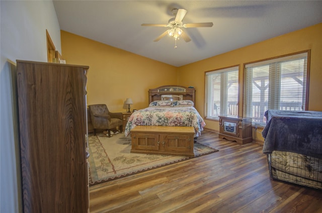 bedroom featuring lofted ceiling, wood finished floors, and ceiling fan