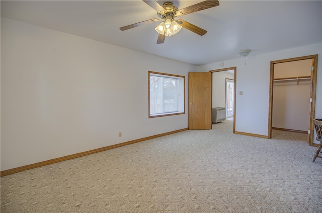 unfurnished bedroom with baseboards, ceiling fan, light carpet, and a closet