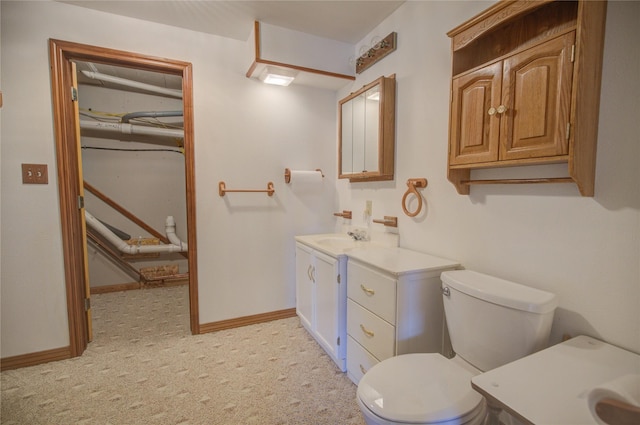 bathroom featuring vanity, baseboards, and toilet