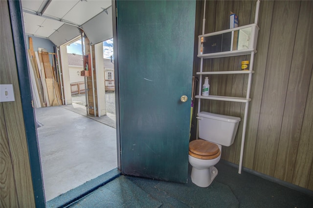 bathroom featuring concrete flooring and toilet