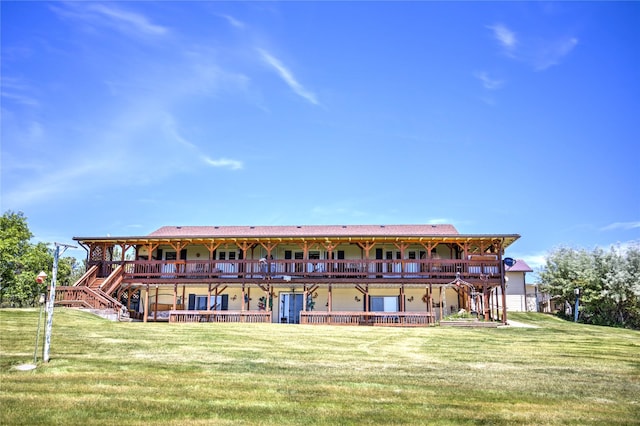 rear view of property featuring a yard and a deck