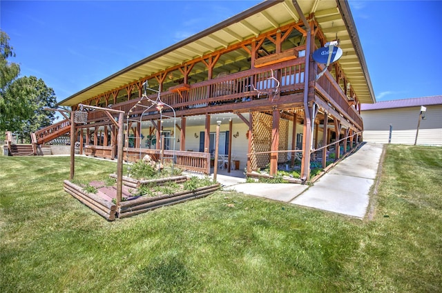 back of property with a lawn and a wooden deck