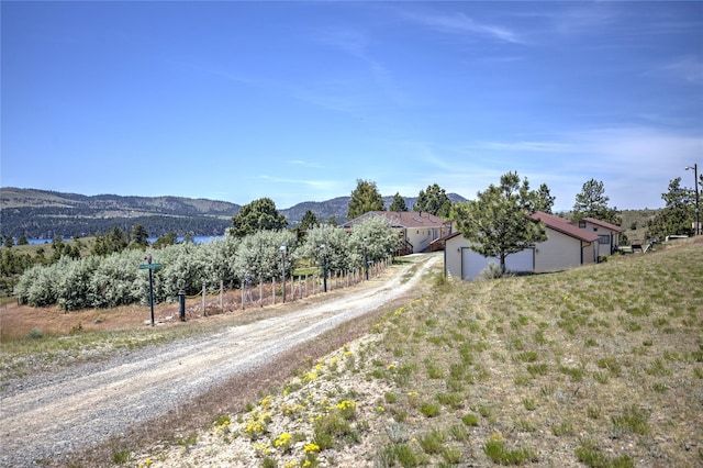 view of road with a mountain view and driveway