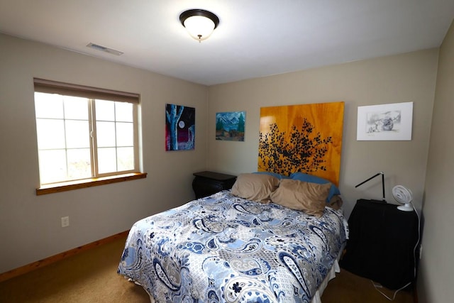 carpeted bedroom with visible vents and baseboards