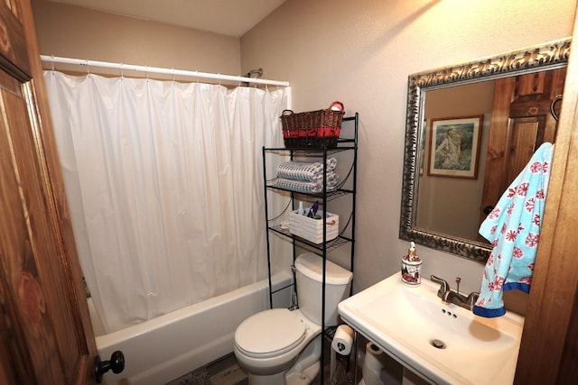 full bath featuring shower / bath combo with shower curtain, a sink, and toilet