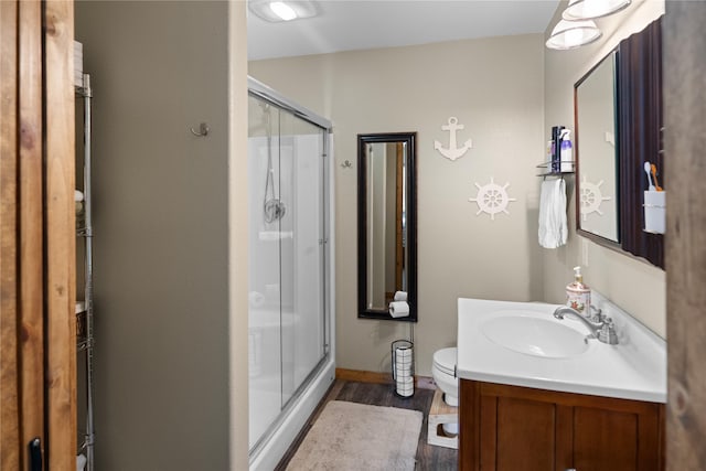 70 Moccasin Ln, Thompson Falls, MT 59873 - full bath featuring wood finished floors, a stall shower, vanity, and toilet