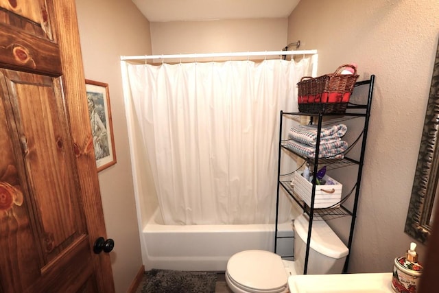 bathroom featuring toilet and shower / tub combo