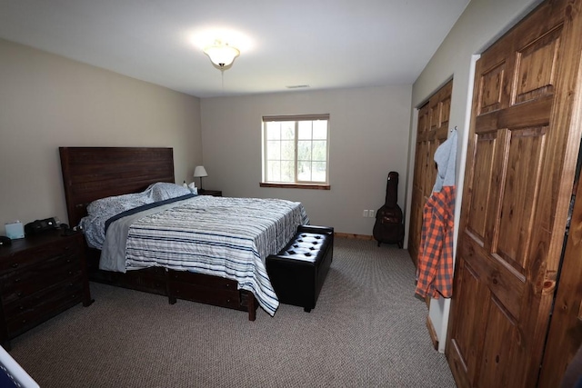 bedroom featuring baseboards, visible vents, and light carpet