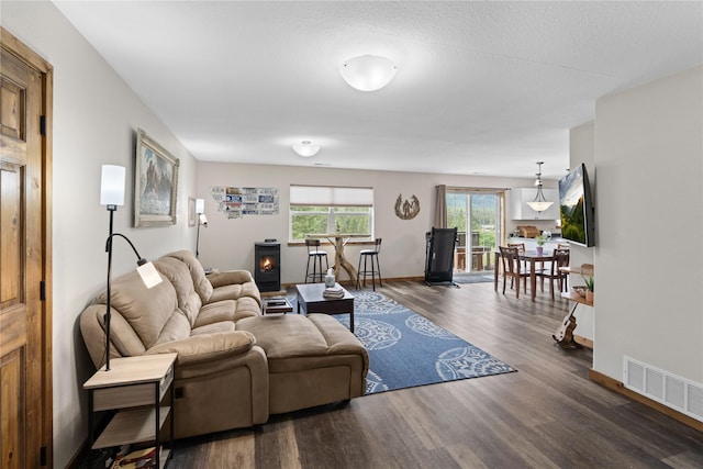70 Moccasin Ln, Thompson Falls, MT 59873 - living room with wood finished floors, a wood stove, and baseboards