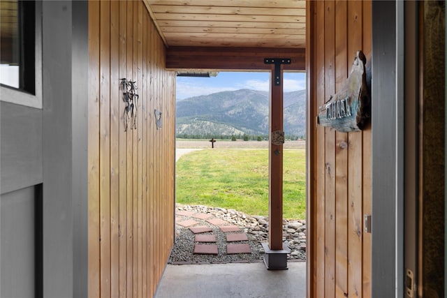 70 Moccasin Ln, Thompson Falls, MT 59873 - doorway with a mountain view, concrete floors, wood walls, and wood ceiling