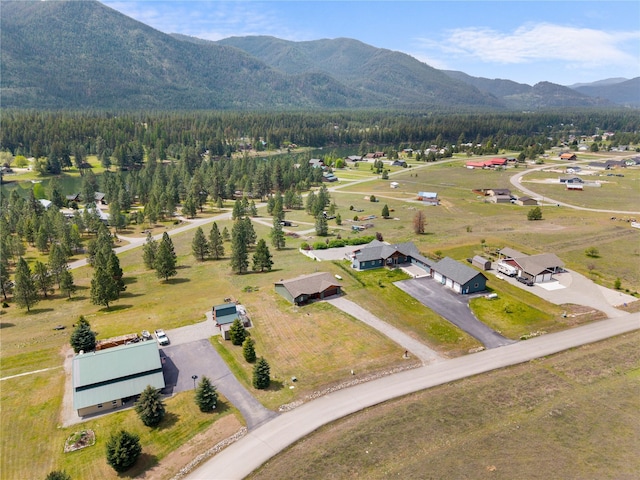 70 Moccasin Ln, Thompson Falls, MT 59873 - aerial overview of property's location with a mountain backdrop and a forest