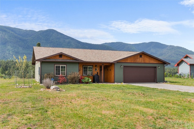 70 Moccasin Ln, Thompson Falls, MT 59873 - ranch-style house featuring a mountain view, a front yard, a garage, and gravel driveway