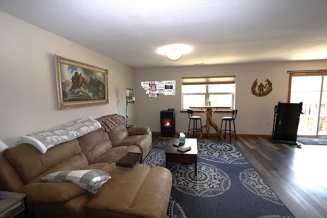 living room with a healthy amount of sunlight, baseboards, and wood finished floors