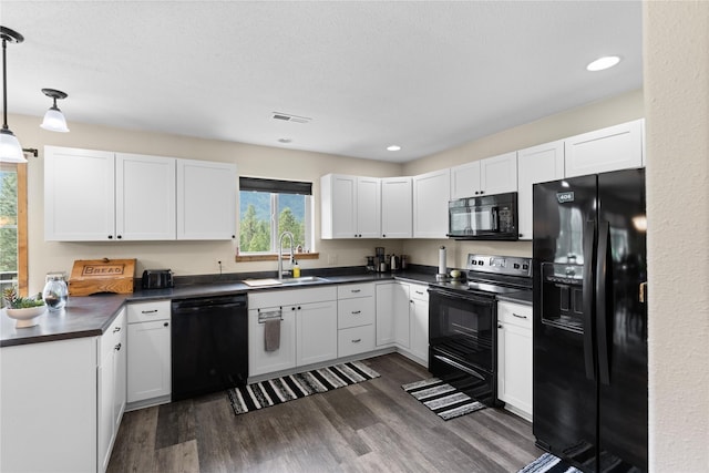 70 Moccasin Ln, Thompson Falls, MT 59873 - kitchen featuring black appliances, a sink, dark countertops, dark wood finished floors, and hanging light fixtures