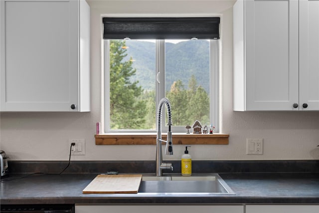 70 Moccasin Ln, Thompson Falls, MT 59873 - kitchen with dark countertops, healthy amount of natural light, a sink, and a textured wall