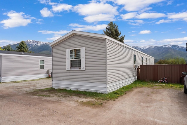 110 Van Sant Rd Unit 4, Kalispell, MT 59901 - view of home's exterior with a mountain view and fence