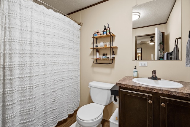 110 Van Sant Rd Unit 4, Kalispell, MT 59901 - full bath featuring a textured ceiling, toilet, vanity, a ceiling fan, and crown molding
