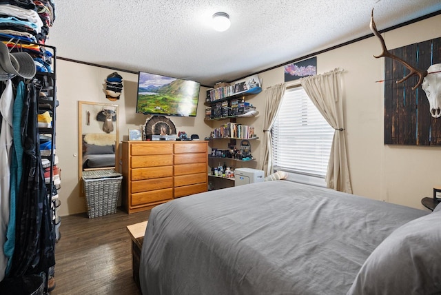 110 Van Sant Rd Unit 4, Kalispell, MT 59901 - bedroom with a textured ceiling and wood finished floors