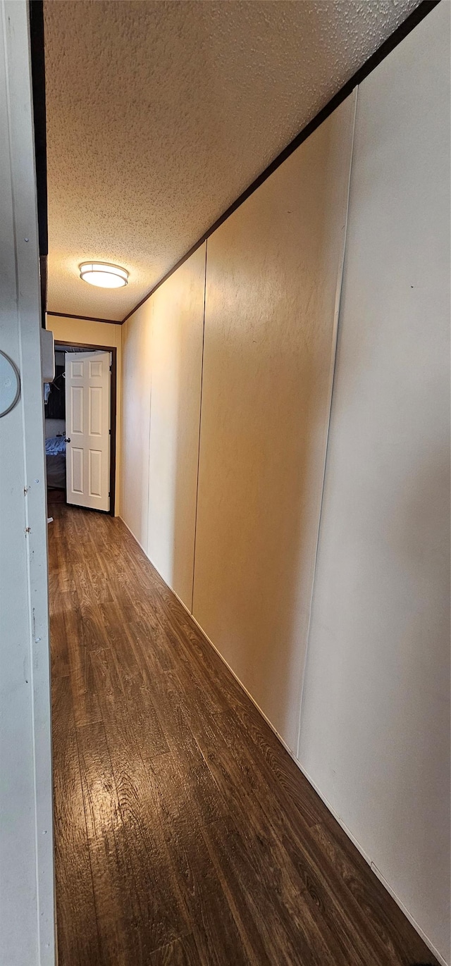 hallway featuring a textured ceiling and wood finished floors