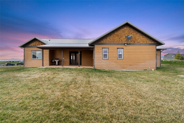 20 Windy Meadow Dr, Townsend, MT 59644 - back of property with a patio, a lawn, and metal roof