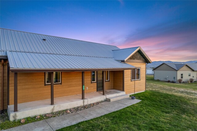 20 Windy Meadow Dr, Townsend, MT 59644 - property exterior at dusk with covered porch and metal roof