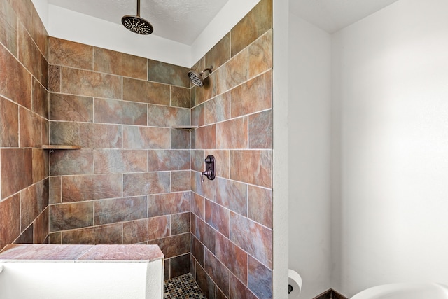 bathroom with tiled shower