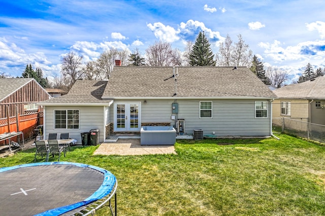 rear view of property with a patio, a fenced backyard, a lawn, a trampoline, and central air condition unit
