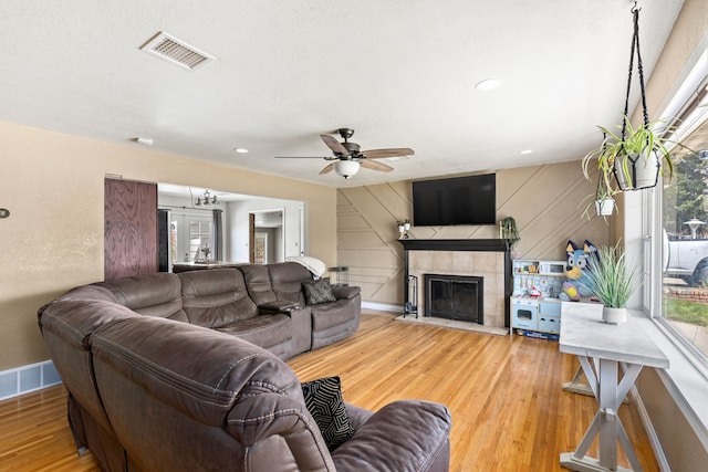 living room with ceiling fan, visible vents, a healthy amount of sunlight, and light wood finished floors