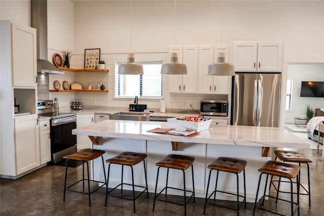 288 Costich Lake Rd, Eureka, MT 59917 - kitchen with concrete flooring, wall chimney exhaust hood, a sink, appliances with stainless steel finishes, and backsplash