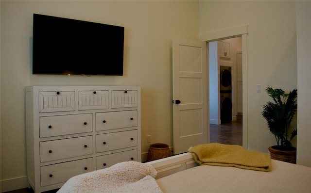 288 Costich Lake Rd, Eureka, MT 59917 - bedroom with baseboards, dark wood finished floors, and stacked washing maching and dryer
