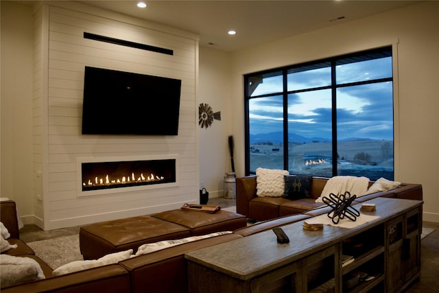 living room with baseboards, a fireplace, and recessed lighting