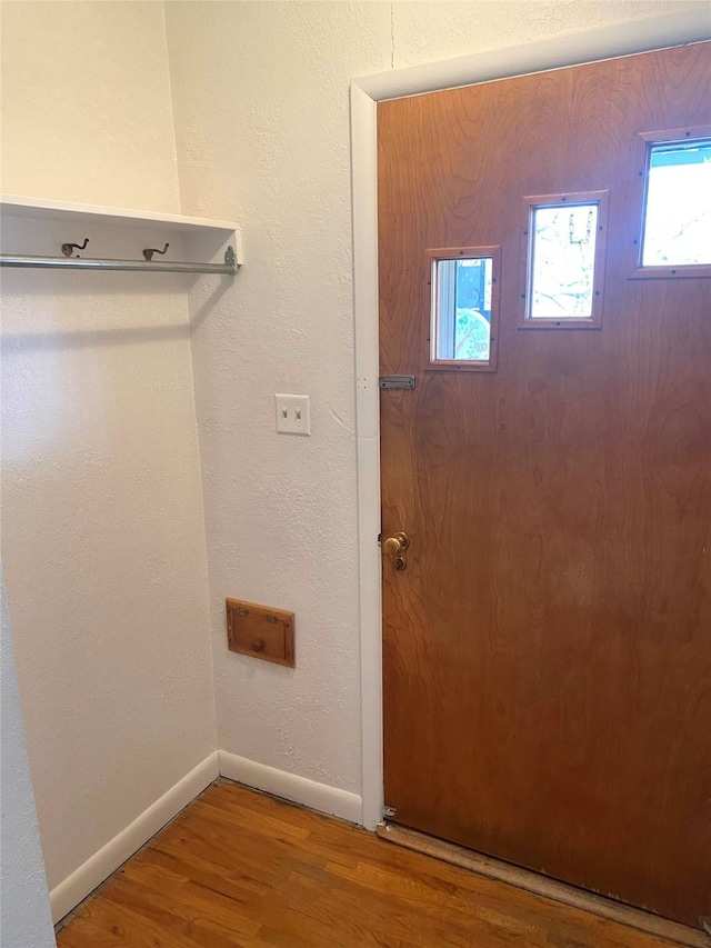 foyer entrance with baseboards and wood finished floors