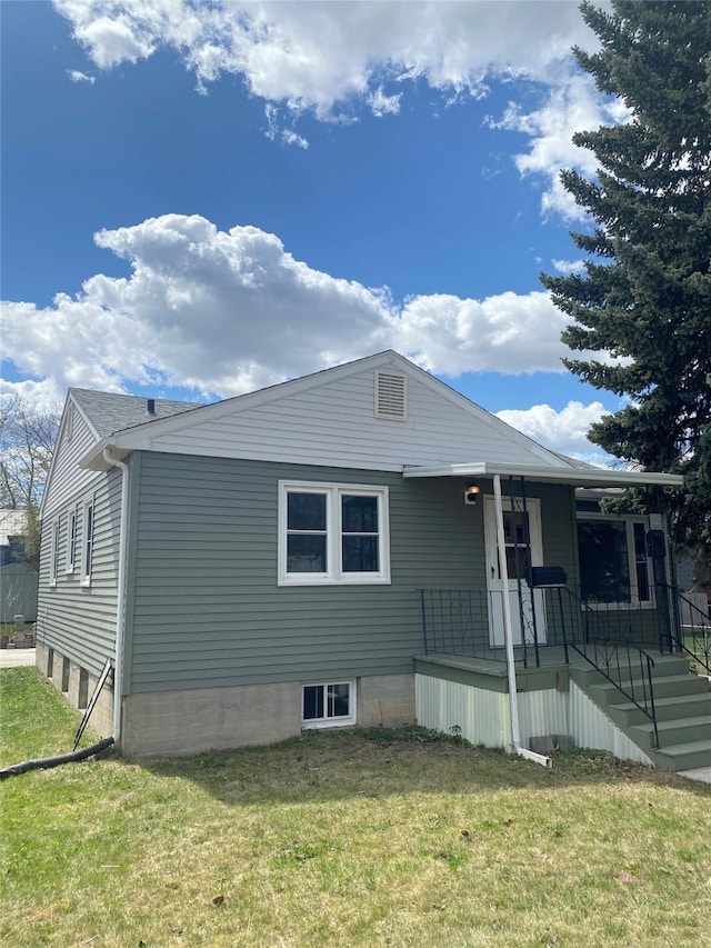 view of front of home featuring covered porch and a front yard