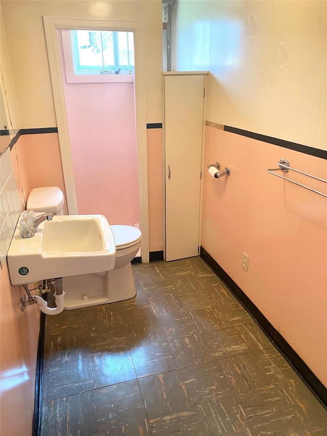half bath with a sink and toilet